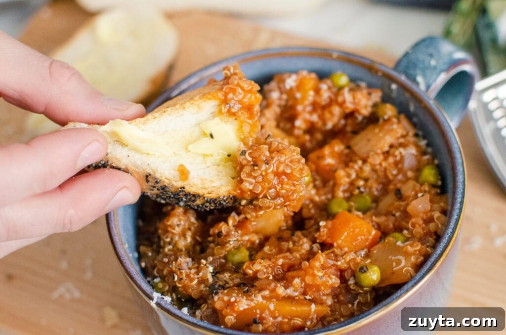 Hearty Quinoa and Vegetable Stew Recipe 2 Quinoa Vegetable Stew in a blue bowl with bread getting dipped into the stew