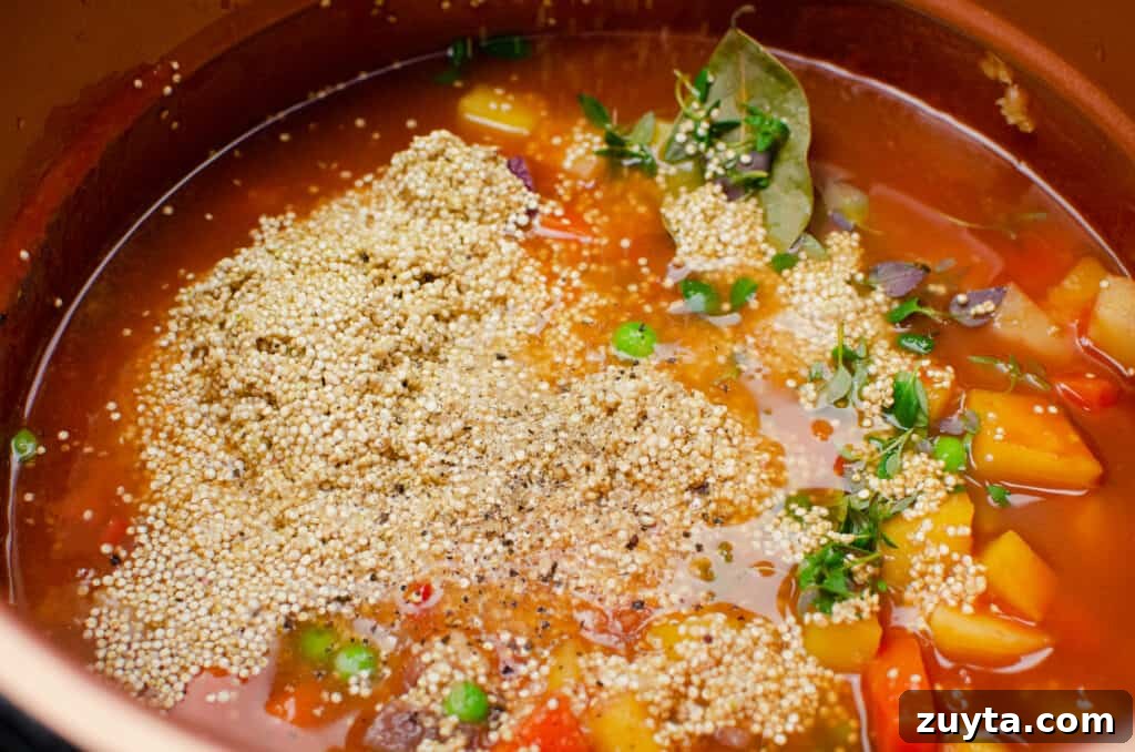 Hearty Quinoa and Vegetable Stew Recipe 7 Salt and pepper being added to the vegetable stew in a pressure cooker pot