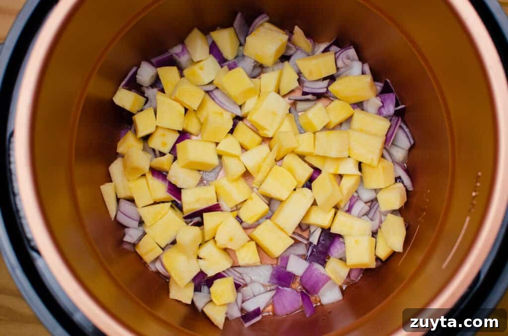 Hearty Quinoa and Vegetable Stew Recipe 8 Chopped swede and red onion frying in olive oil in a pressure cooker pot