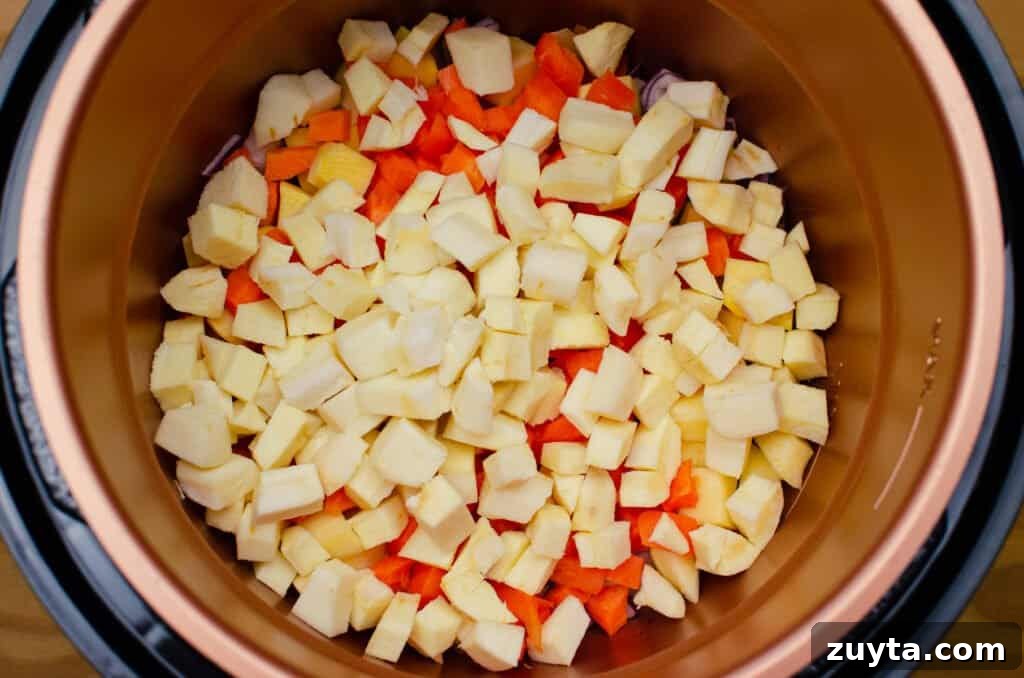 Hearty Quinoa and Vegetable Stew Recipe 10 Chopped Parsnip, Carrot, Swede and red onion frying in olive oil in a pressure cooker pot