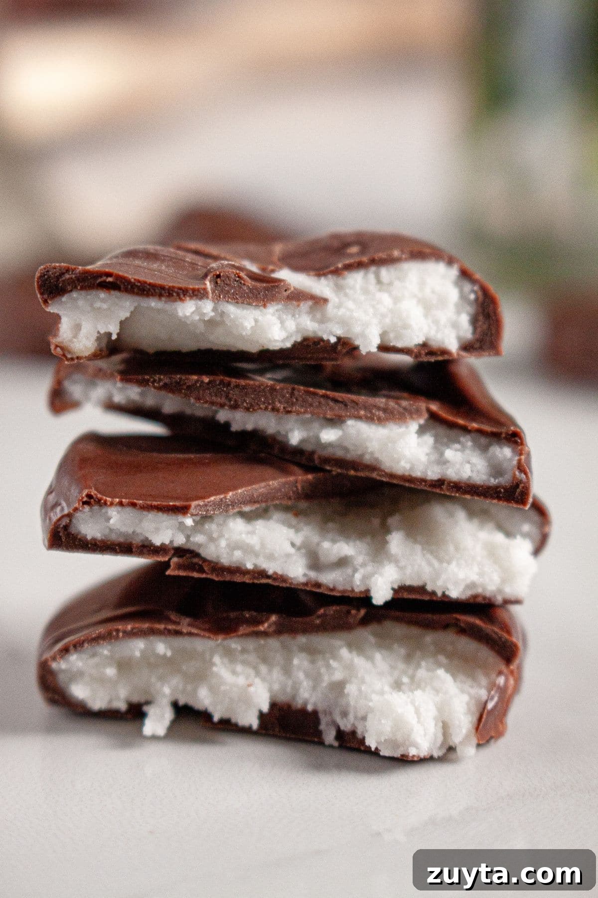 Peppermint patties stacked on a counter to show the inside.