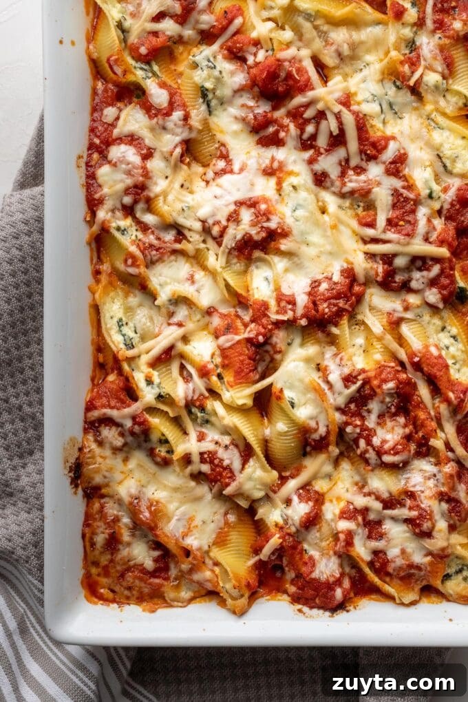 Creamy Spinach and Ricotta Stuffed Shells Recipe 2 Overhead image of stuffed shells with melted cheese on top.