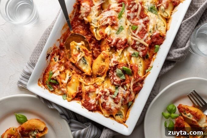 Creamy Spinach and Ricotta Stuffed Shells Recipe 6 A large baking dish filled with baked stuffed shells filled with ricotta and spinach.