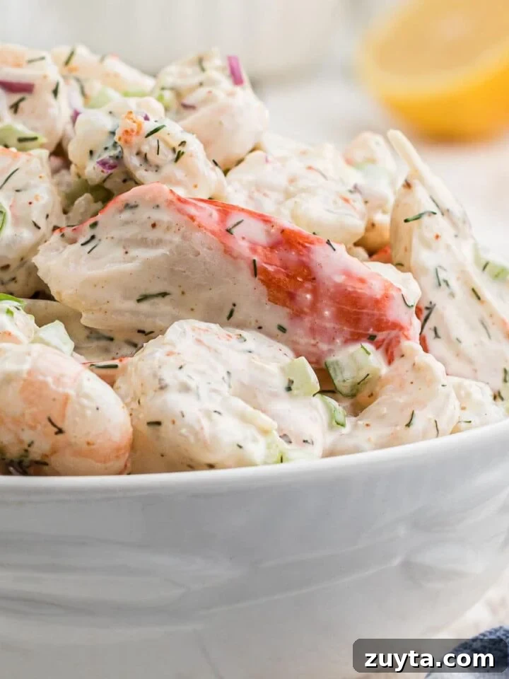 Summer Pesto Pasta Salad with Cherry Tomatoes and Mozzarella 10 A close up of a bowl of southern seafood salad recipe.