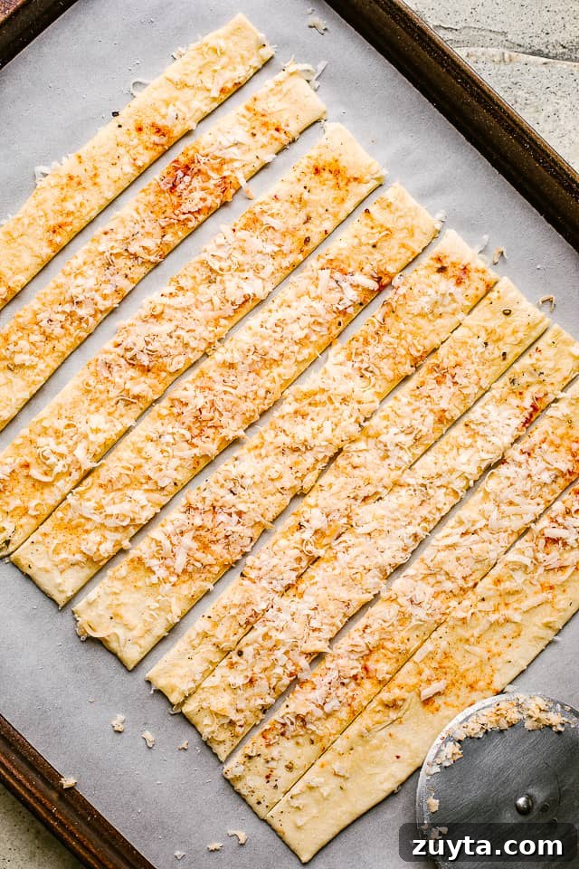 Puff pastry layered with spices and cheese, then sliced. Puff pastry layered with spices and cheese, then sliced.