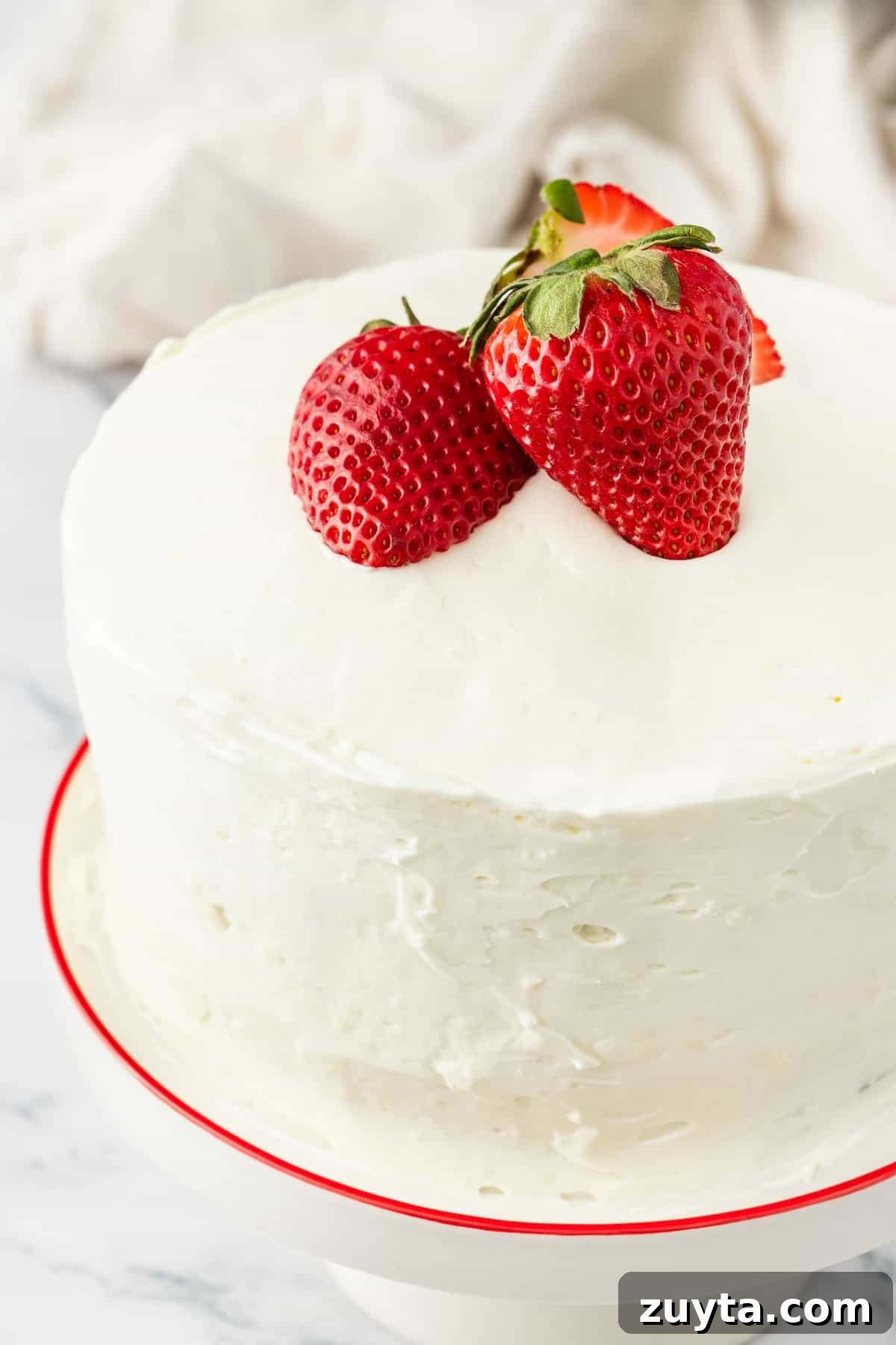 white frosted cake with strawberries