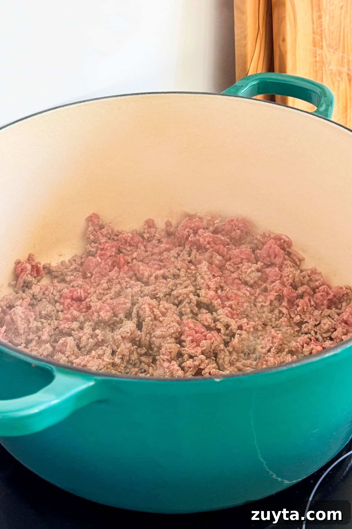 Spicy Chipotle Ground Beef and Cabbage Casserole Recipe 5 Ground beef cooking in a pot.