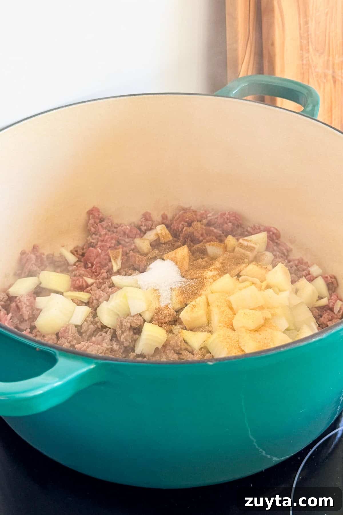 Spicy Chipotle Ground Beef and Cabbage Casserole Recipe 6 Onions added to the pot.
