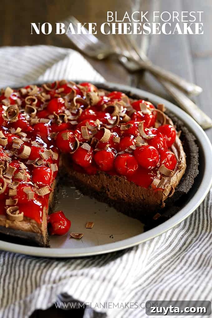 My Black Forest No Bake Cheesecake takes just 10 minutes to prepare and is an absolute must for chocolate lovers! A Black Forest No Bake Cheesecake with a slice removed rests on a striped napkin.