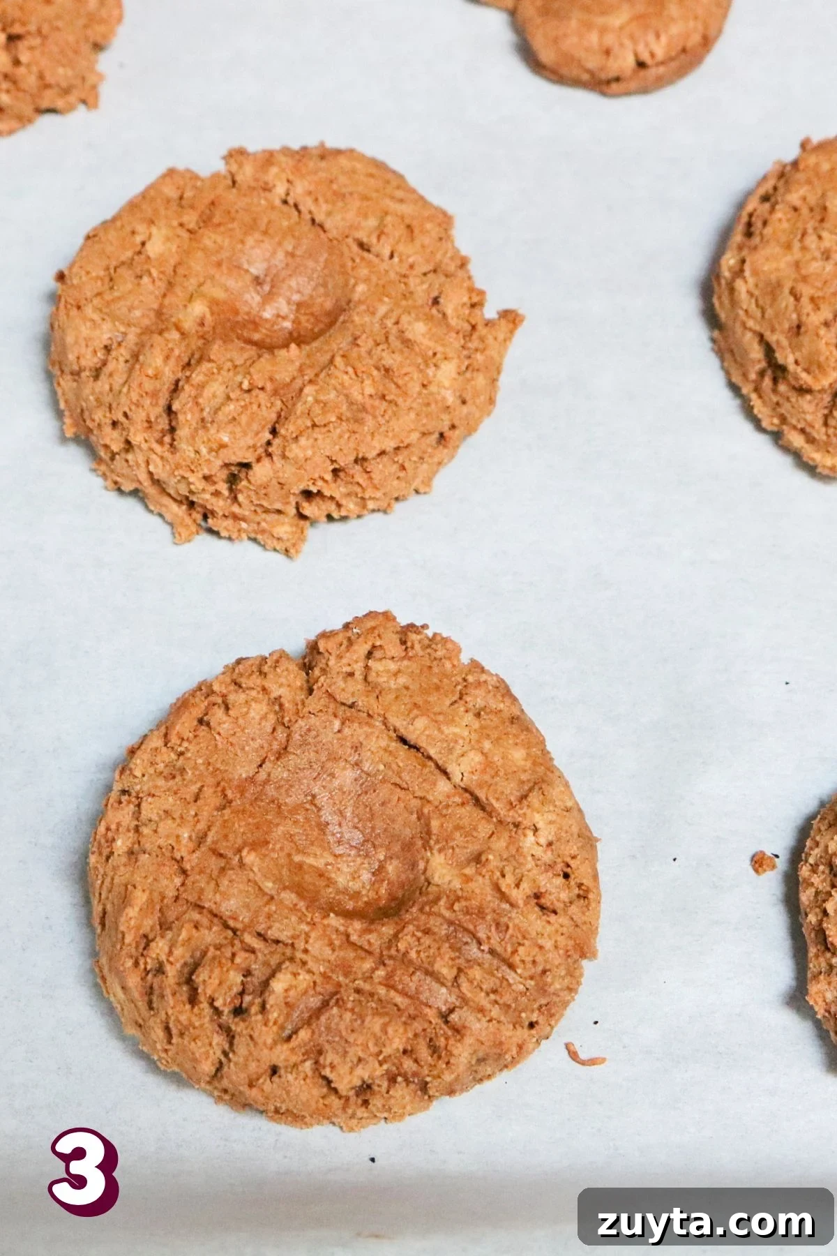 Flourless Peanut Butter and Jam Cookies (Dairy-Free Recipe) 6 Flourless peanut butter cookies on parchment paper.