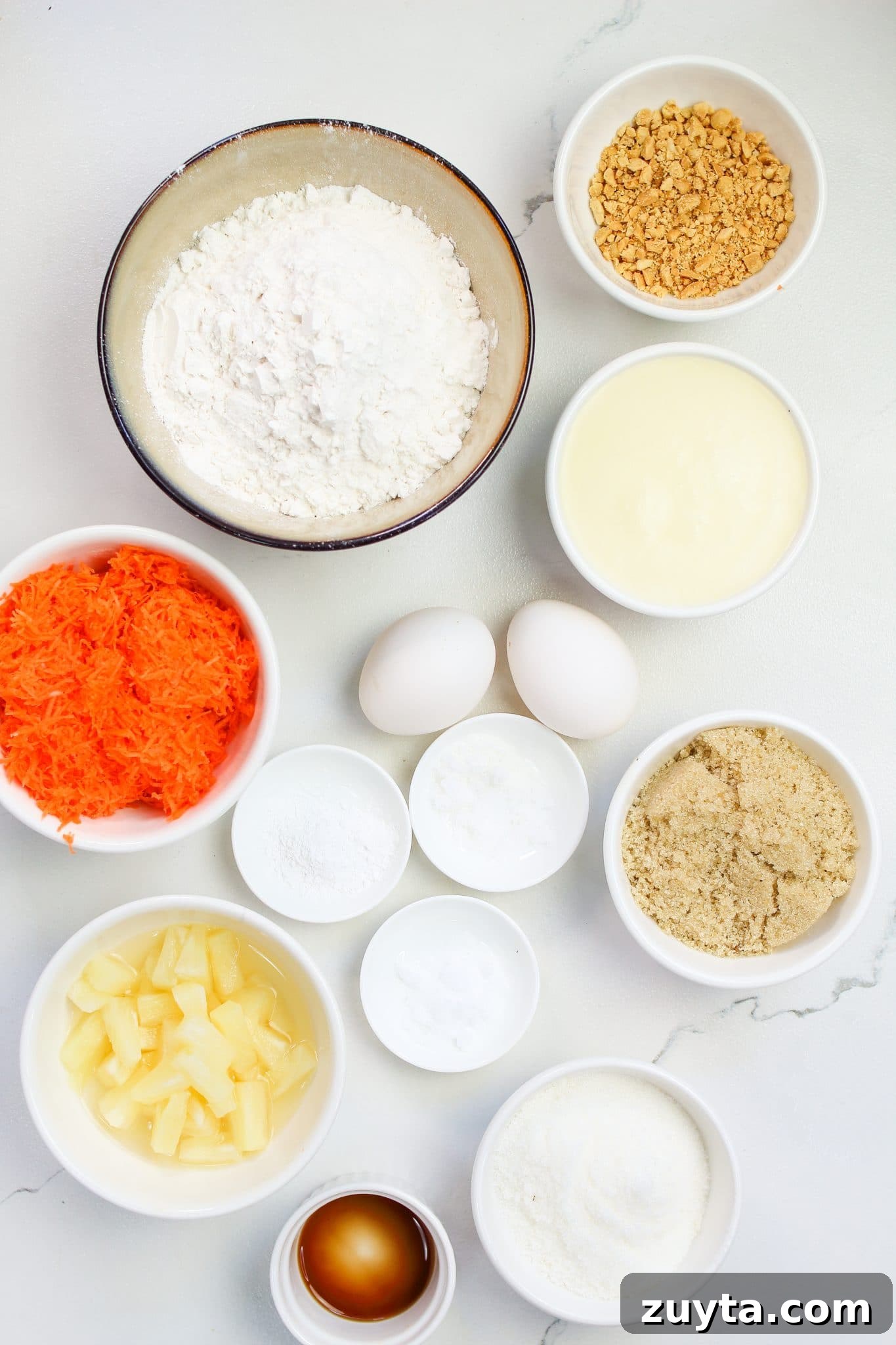 Carrot Cake Cupcakes Recipe with Cream Cheese Frosting 3 Ingredients for cupcakes recipe: flour, sugar, brown sugar, baking powder, salt, eggs, pineapple, vanilla, grated carrots, chopped pecans.