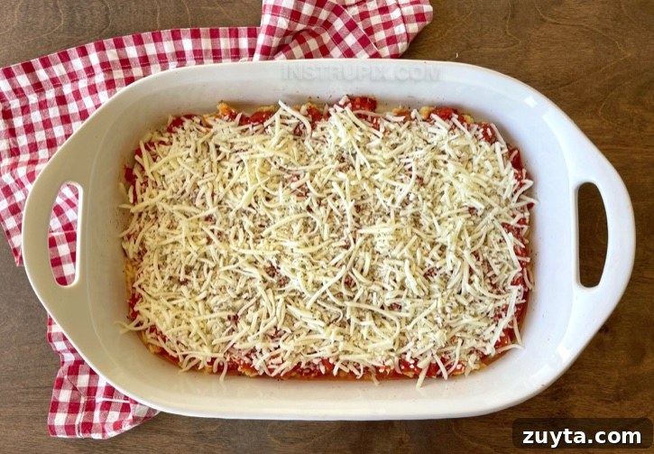 Cheesy Cauliflower Pizza Casserole Recipe 6 Keto Cauliflower Pizza Casserole | I'm always looking for low carb meals that my entire family will love, and this quick and easy baked cauliflower casserole is absolutely perfect! Even my kids love it, and you can customize it with the pizza toppings of your choice like pepperoni, mushrooms, olives, peppers, and more!