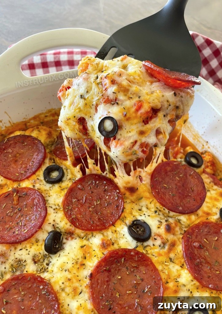 Cheesy Cauliflower Pizza Casserole Recipe 8 Easy Keto Cauliflower Pizza Casserole | The best quick and easy low carb dinner recipe! Great for your entire family, too! This baked casserole is loaded with veggies, pasta sauce, cheese, and the toppings of your choice like pepperoni. It's perfect for busy weeknight meals when you're tired and hungry. Even my picky kids love it.