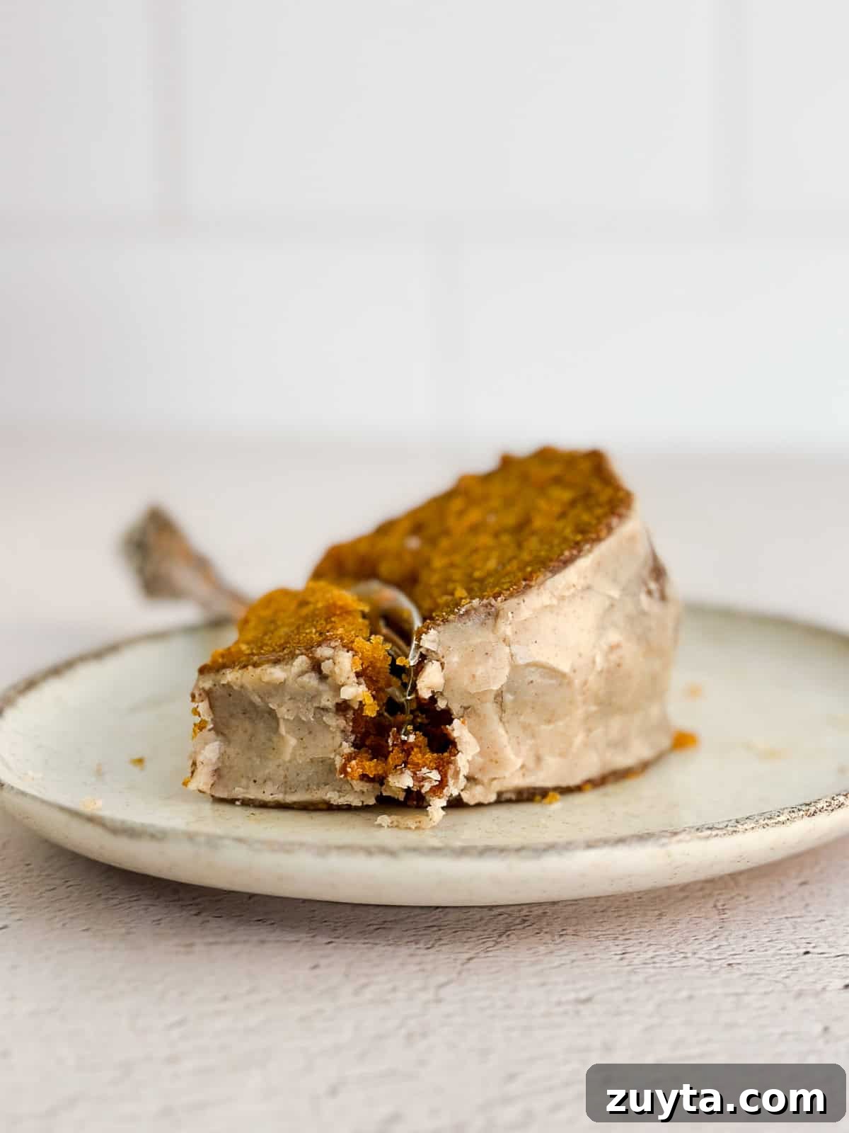 Moist Pumpkin Bundt Cake Recipe with Cinnamon Glaze 11 a piece of cake on a plate showing the texture of the crumb and the glaze.
