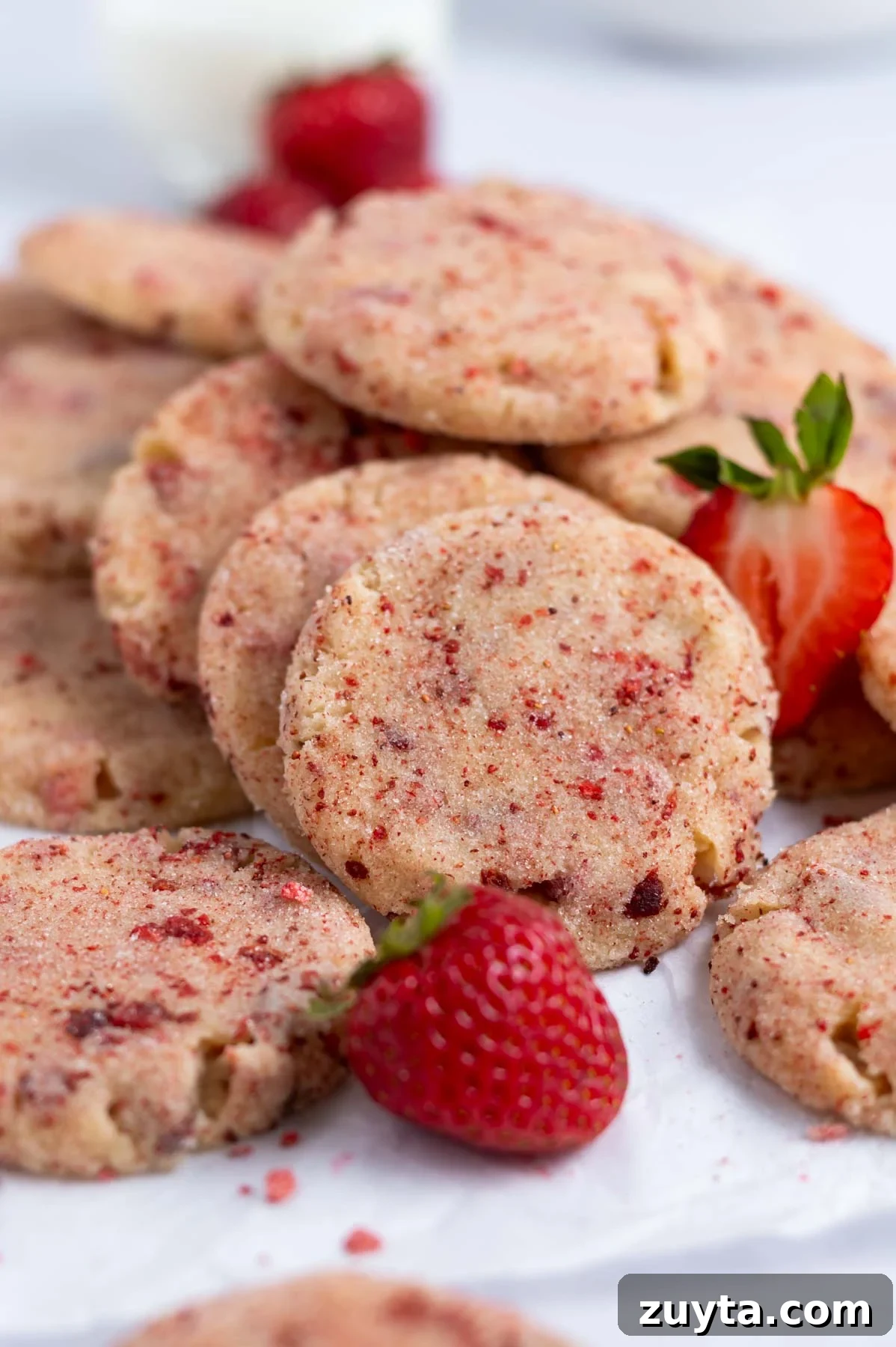 pile of strawberry sugar cookies with fresh strawberries
