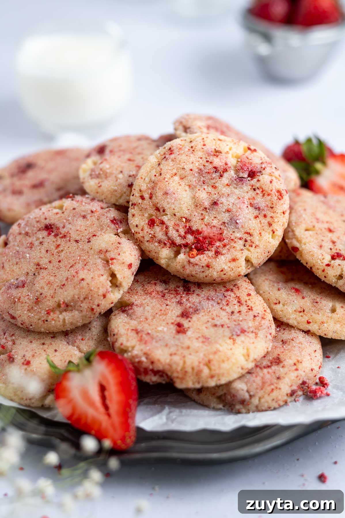 plate of cookies with milk in the background