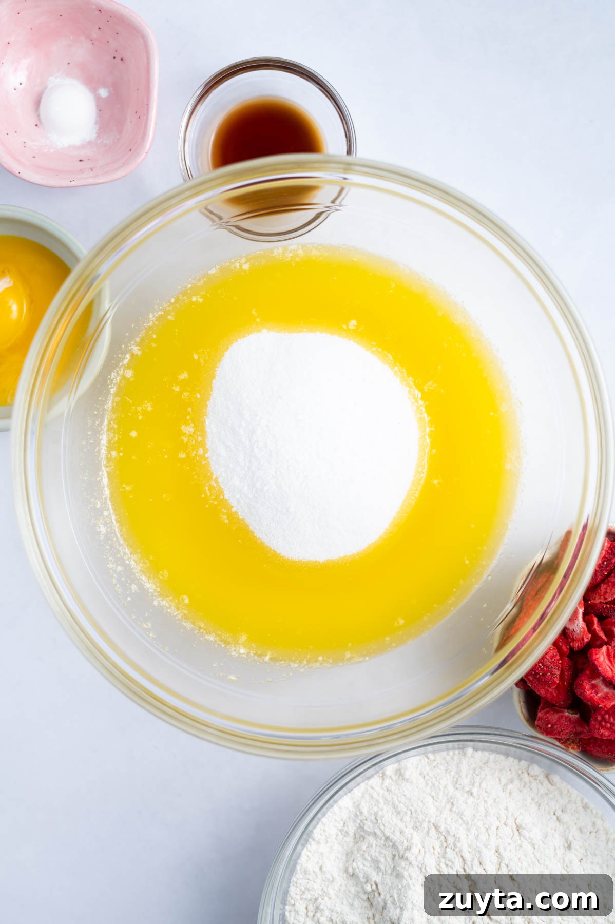 white sugar added to melted butter in a mixing bowl