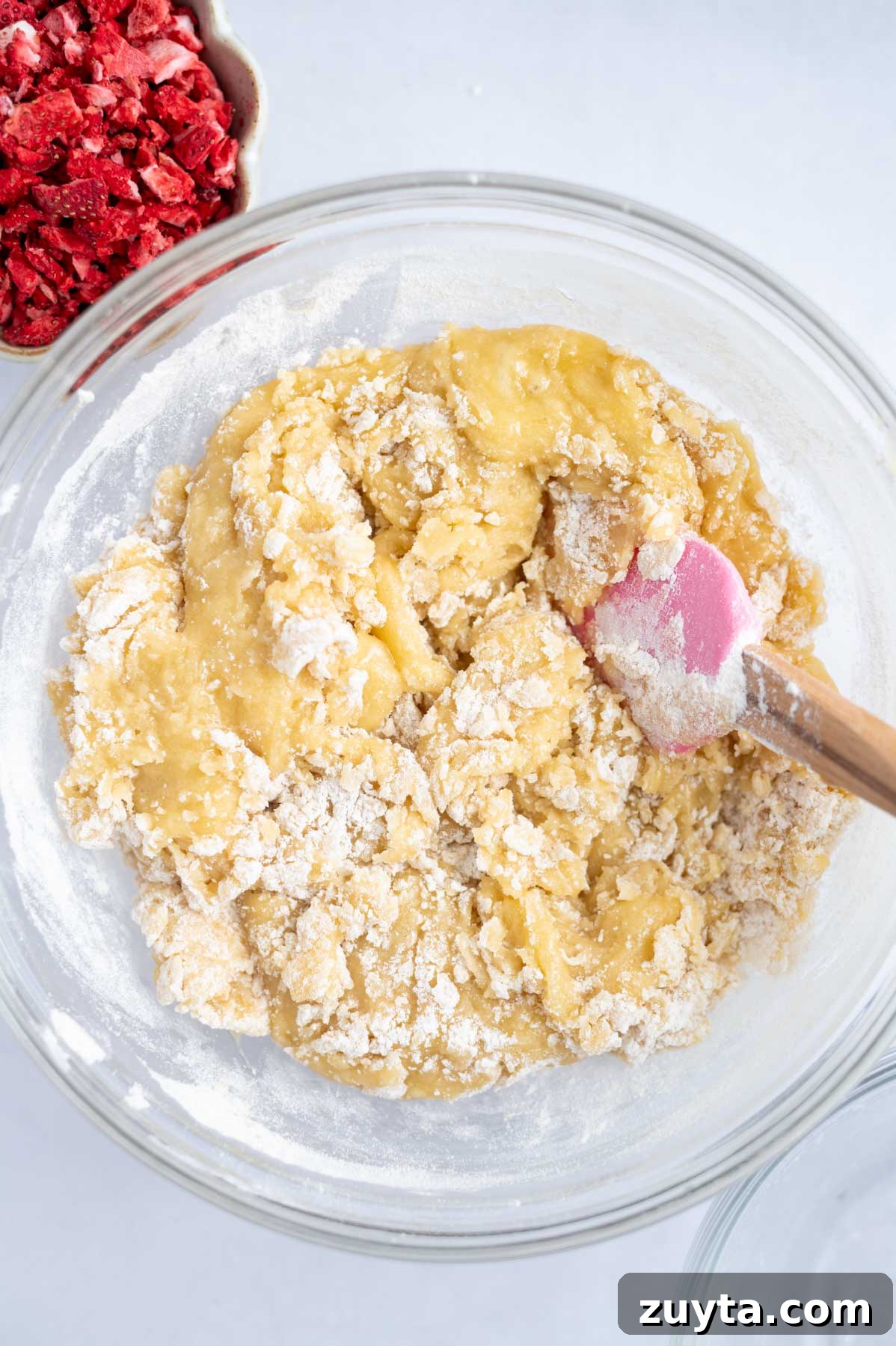 flour mixed until just a few streaks remain in a mixing bowl