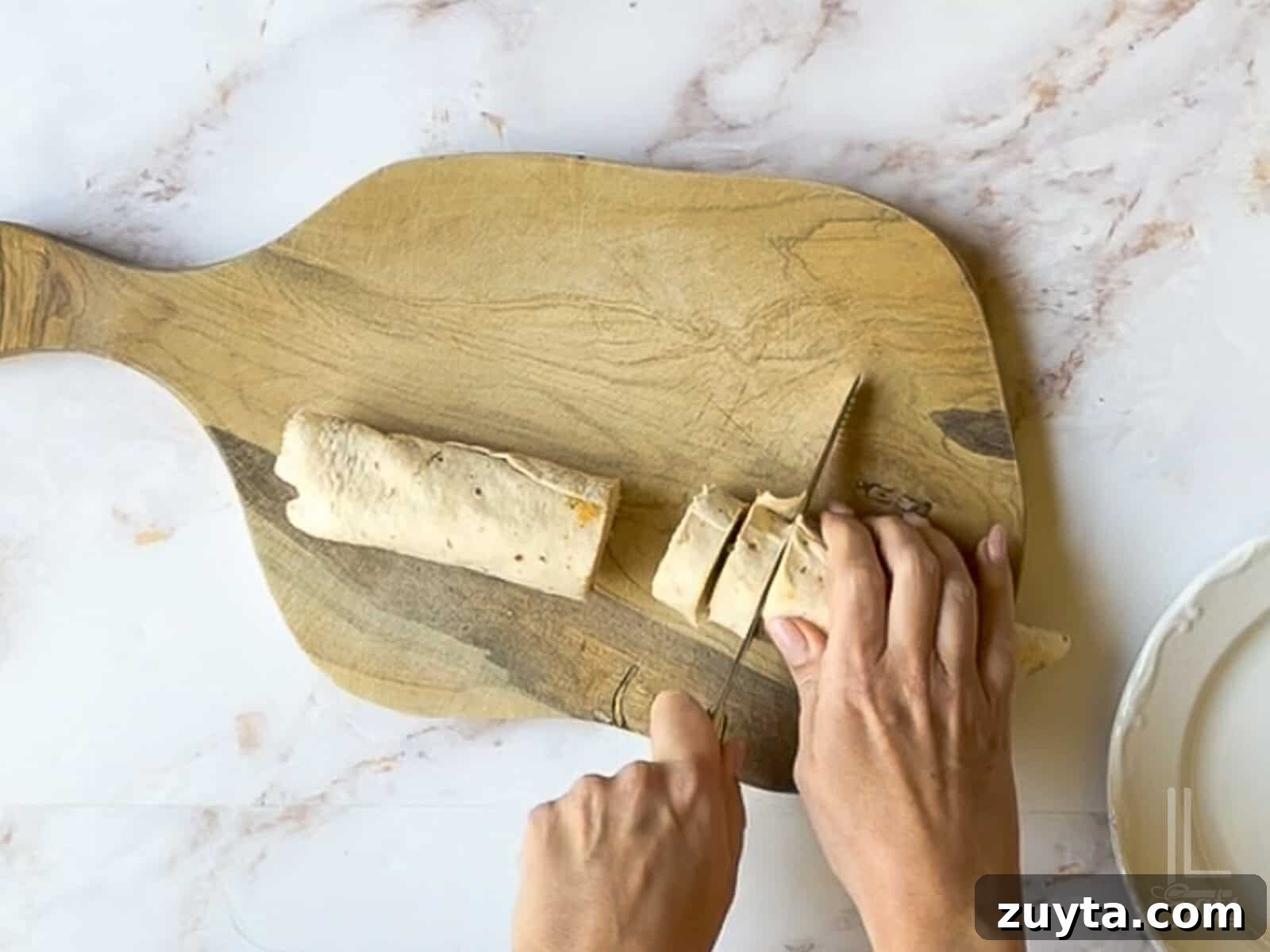 Buffalo Chicken Pinwheels Appetizer Recipe 10 cutting unwrapped tortilla with a knife.
