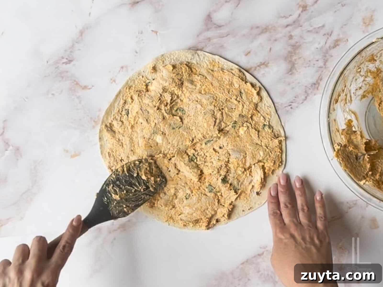 Buffalo Chicken Pinwheels Appetizer Recipe 7 spreading buffalo cream cheese mixture onto a large tortilla.