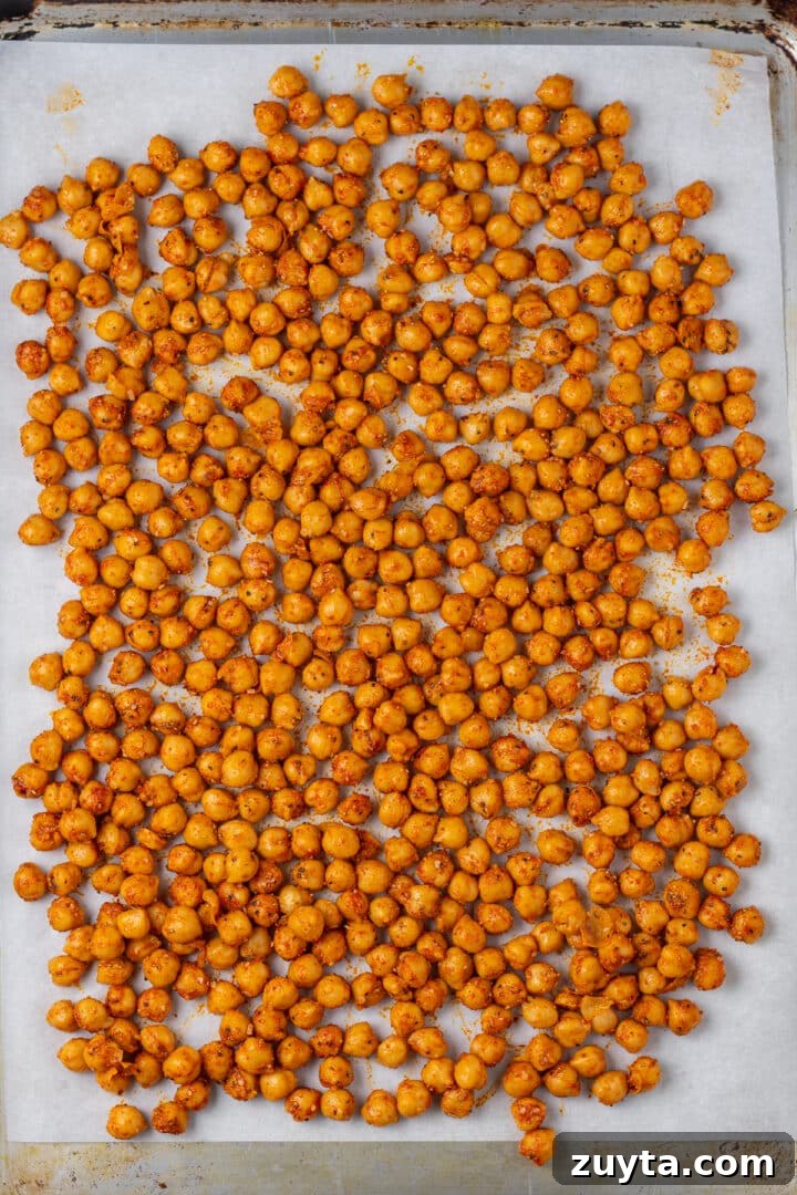 seasoned uncooked chickpeas on a sheet pan