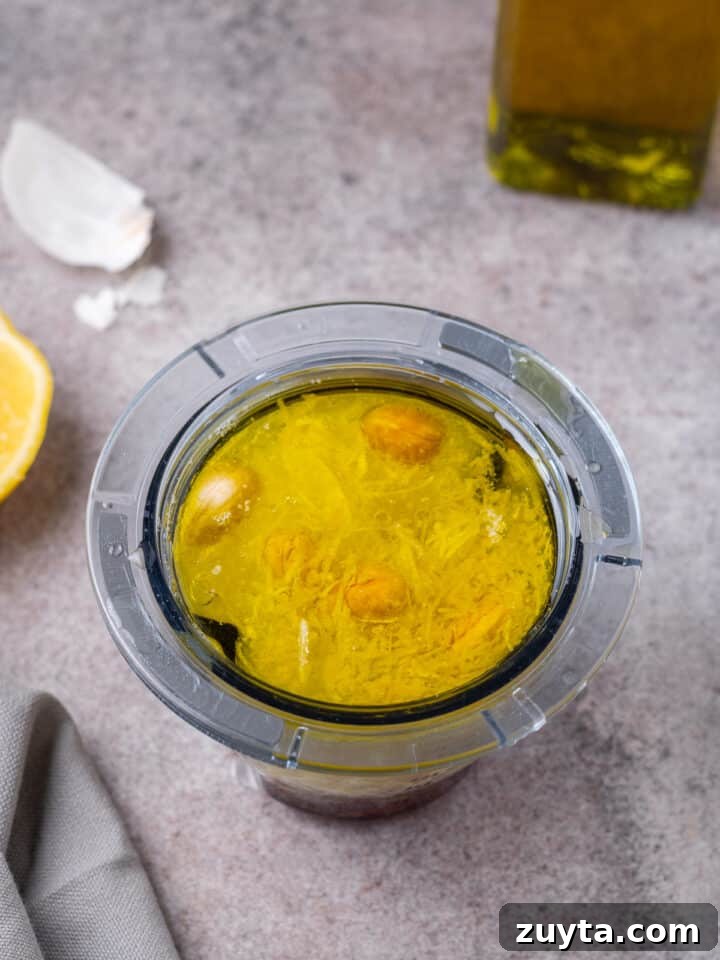 cashews, lemon zest, garlic, lemon juice and olive oil in a small blender cup