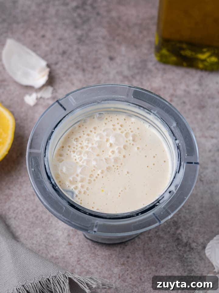 smooth and creamy blended cashew dressing in a small blender cup