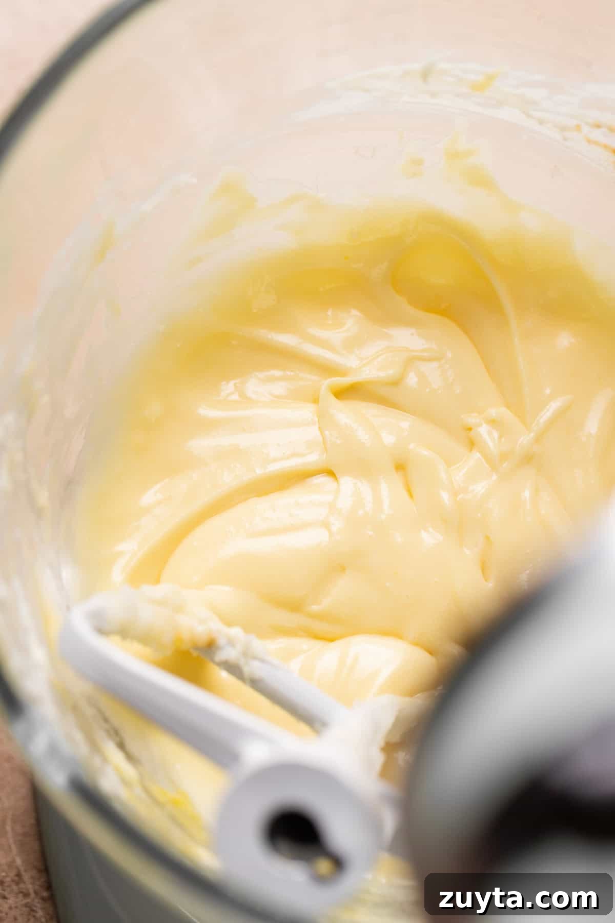 Pumpkin Cheesecake Cookies Recipe 6 A glass mixing bowl with the creamed butter, cream cheese, sugars, and egg.