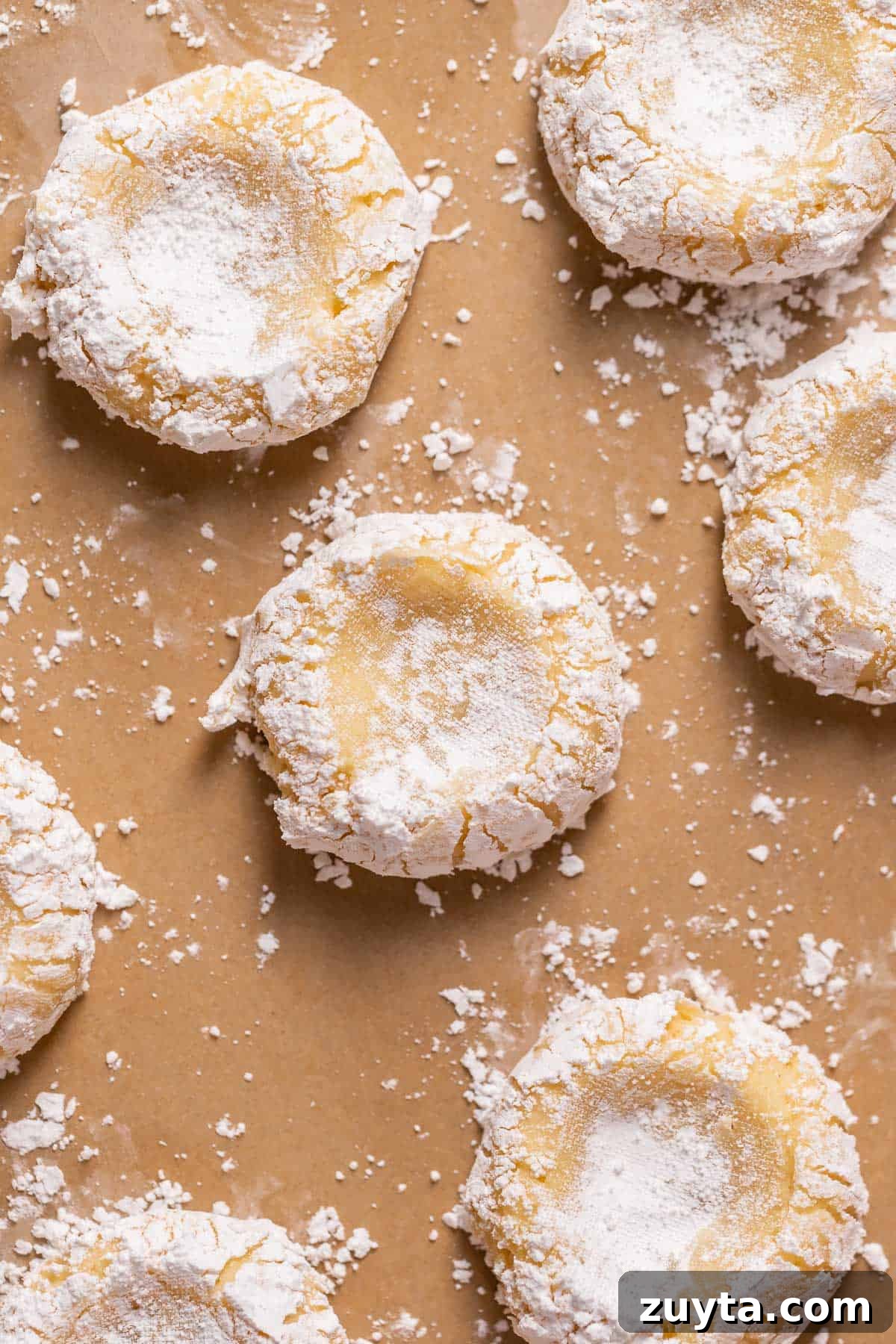 Pumpkin Cheesecake Cookies Recipe 8 Cookies indented on a baking sheet before adding the cheesecake filling.