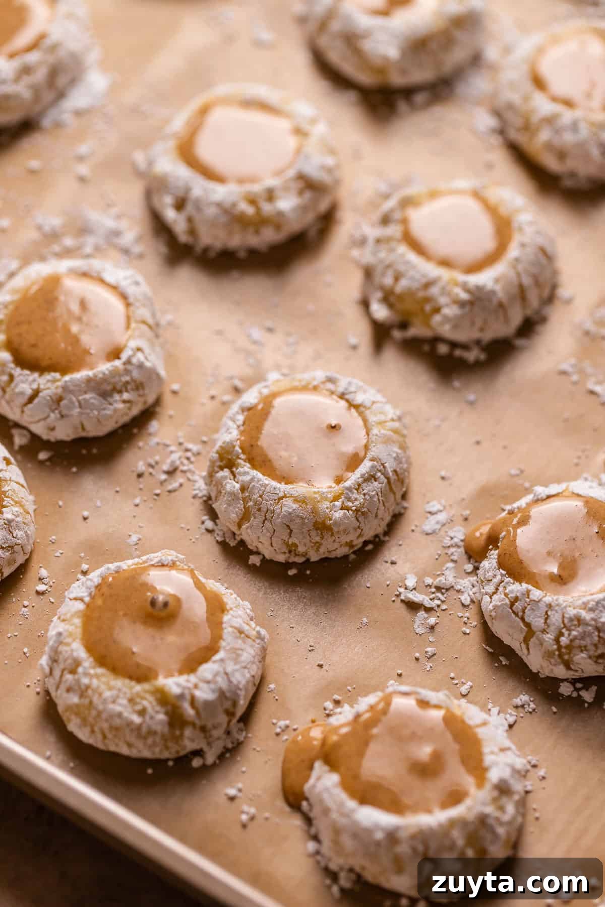 Pumpkin Cheesecake Cookies Recipe 9 Pumpkin filled cheesecake cookies on a baking sheet before baking.