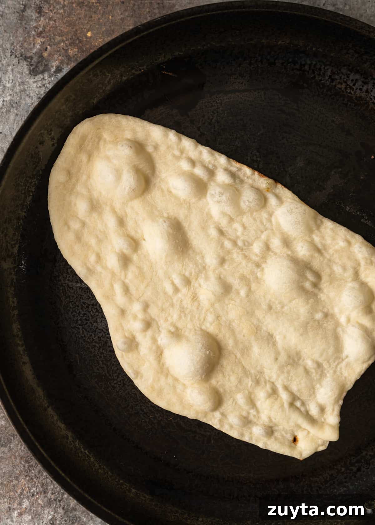 How to Make Naan at Home: Authentic Indian Flatbread 10 cooking bottom in skillet