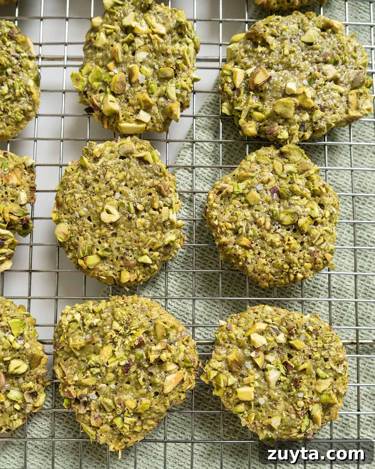 Classic Italian Pistachio Cookies Recipe 2 Italian pistachio cookies on a cooling rack.