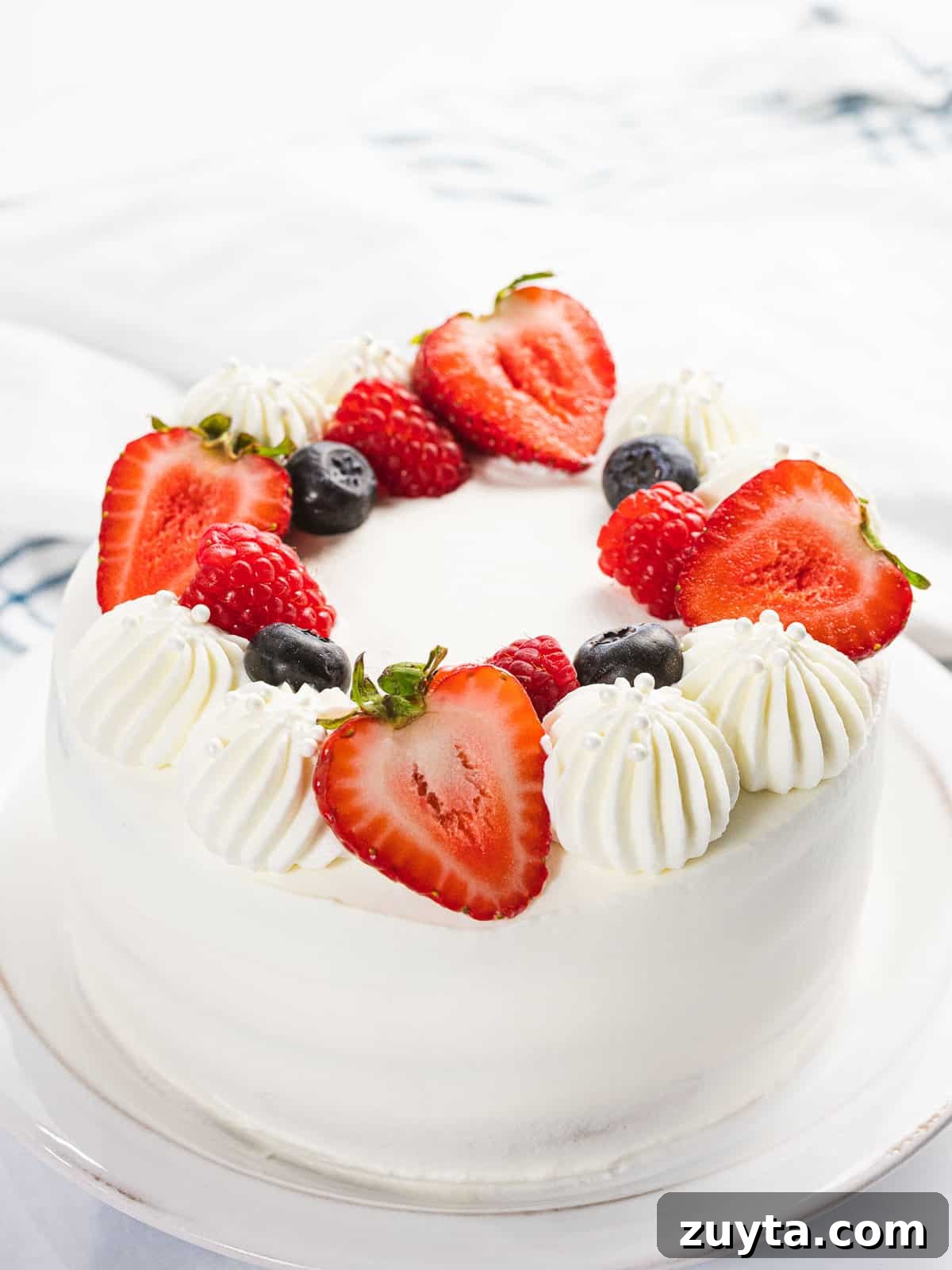 Fluffy Chantilly Cake with Fresh Berries Recipe 2 Berry Chantilly cake with fresh strawberries, blueberries, and raspberries.