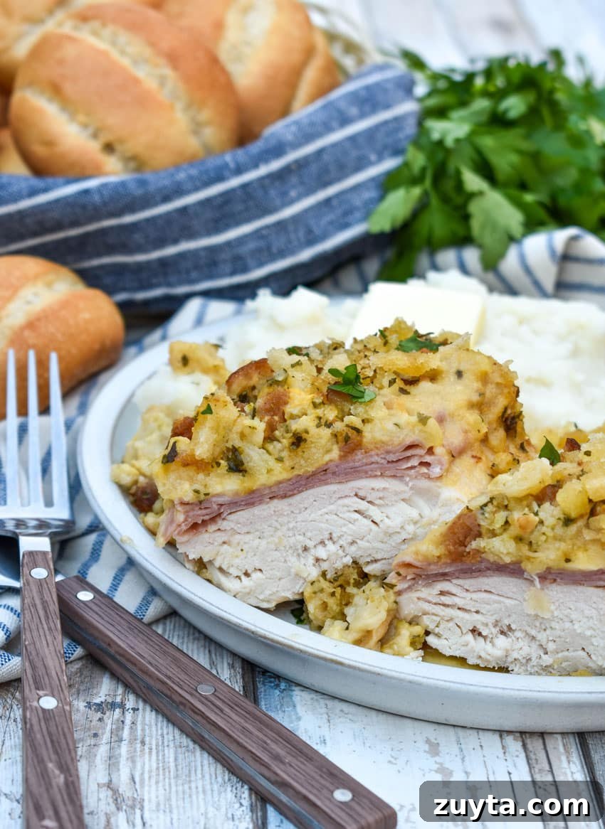 Slow Cooker Chicken Cordon Bleu Recipe with Ham and Swiss 5 slow cooker chicken cordon bleu next to mashed potatoes and canned green beans on a white plate