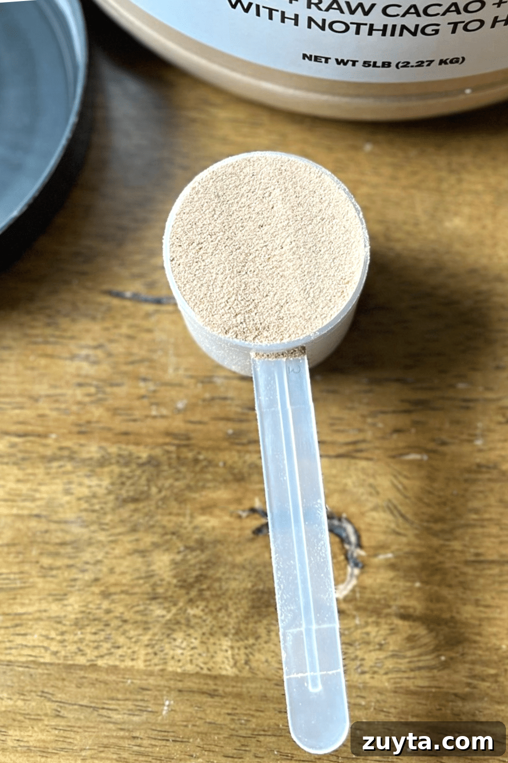 Naked Nutrition Review: Top 3 Protein Powders Compared 4 One scoop of Naked Nutrition's indulgent chocolate whey protein powder, ready for a protein-packed shake.