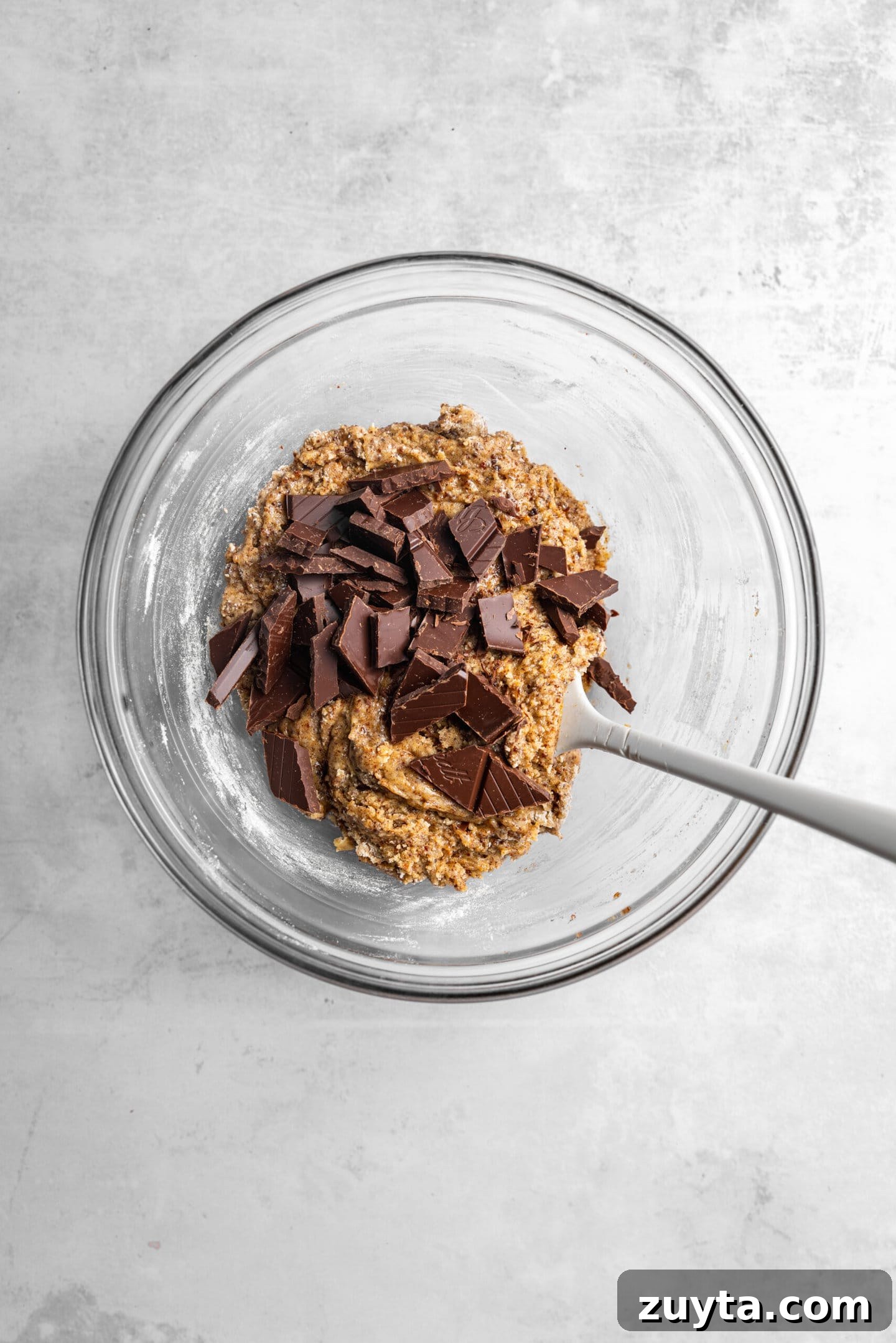Small-Batch Brown Butter Chocolate Chip Cookie Recipe 10 Chocolate chunks being folded into the cookie dough