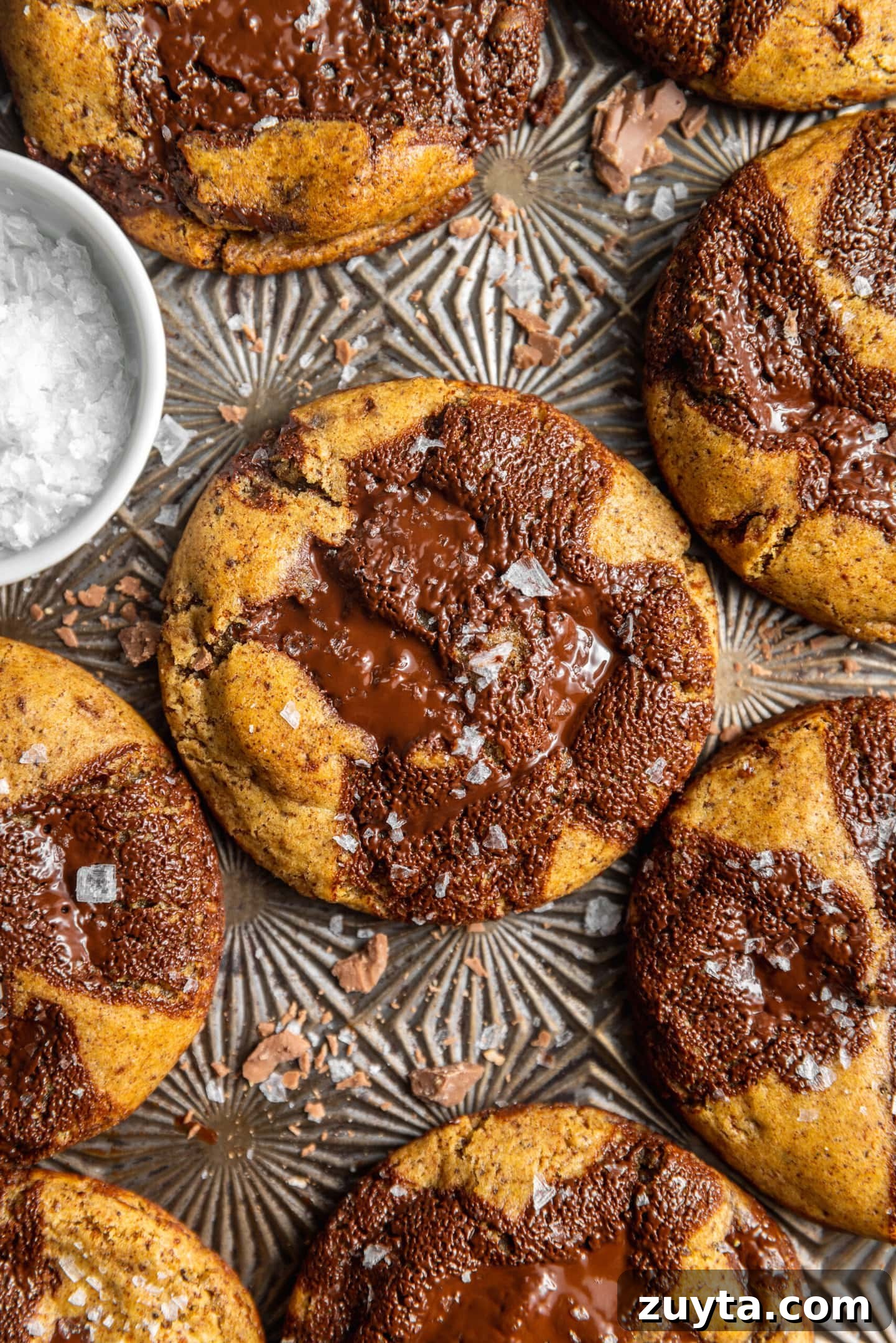 Small-Batch Brown Butter Chocolate Chip Cookie Recipe 14 Close up of fresh baked cookies with flaky salt and chocolate puddles on top