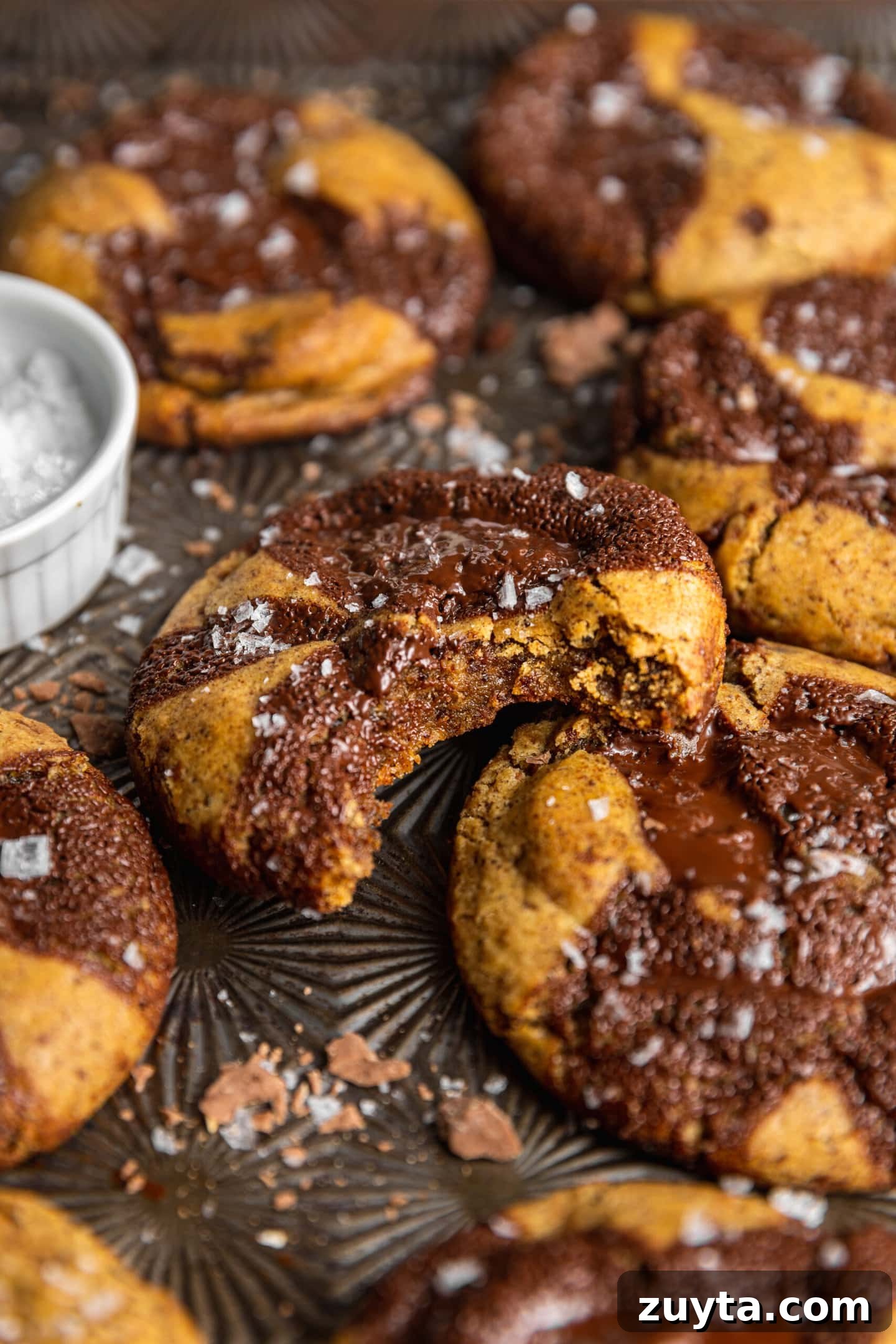 Small-Batch Brown Butter Chocolate Chip Cookie Recipe 15 Close up of brown butter chocolate chip cookie on baking sheet with a bite missing