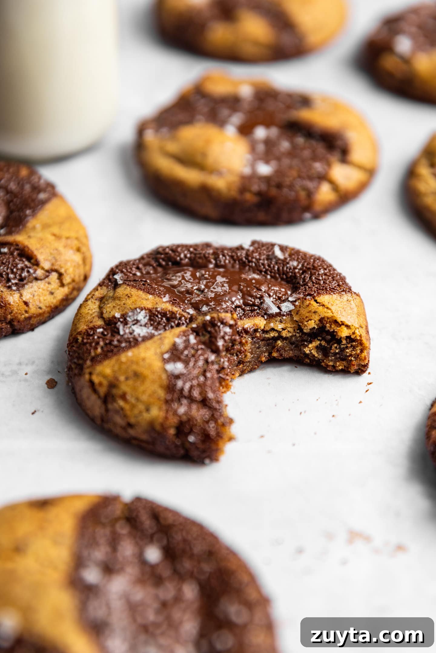 Small-Batch Brown Butter Chocolate Chip Cookie Recipe 2 Close up of cookie with a bite missing next to a glass of milk