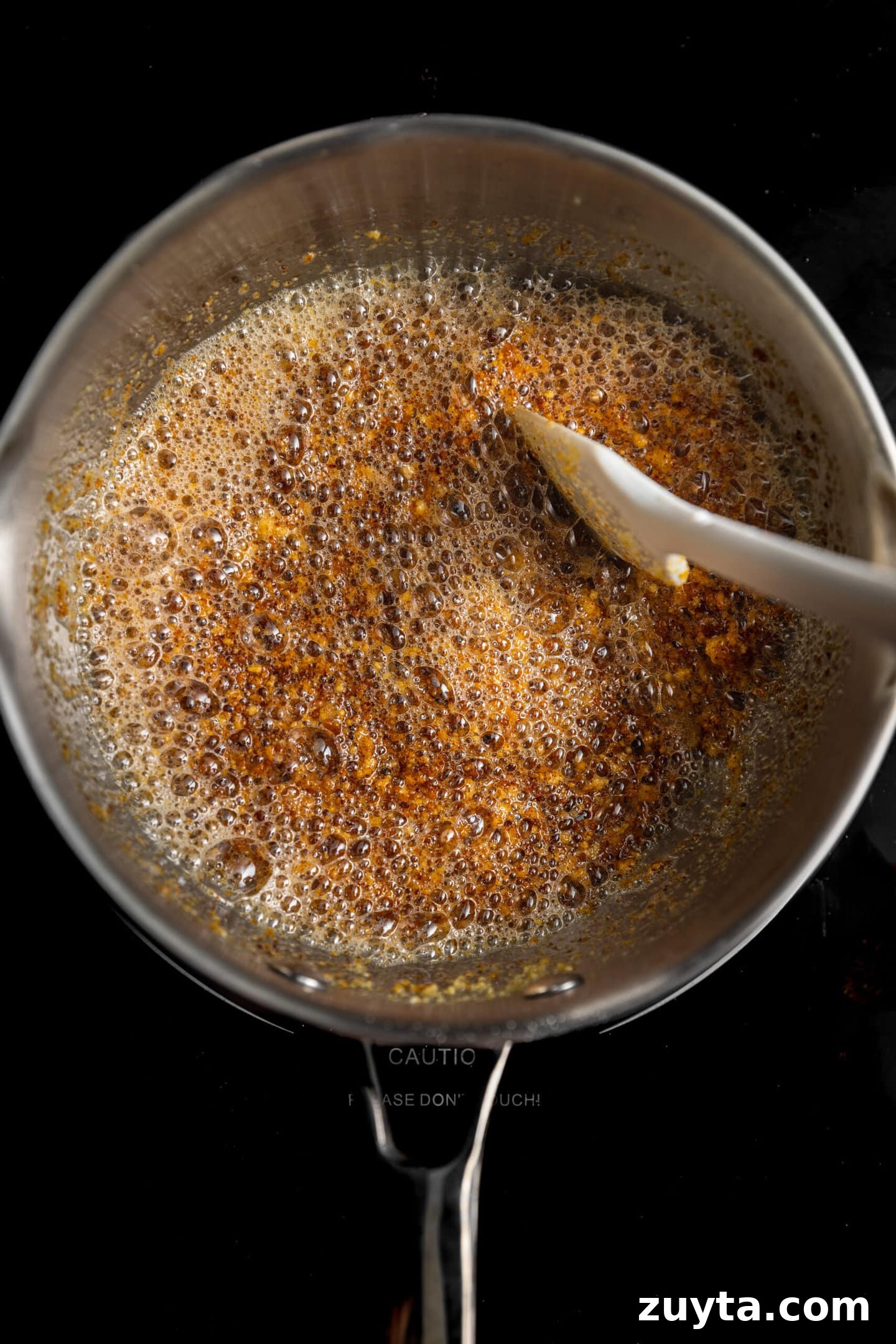 Small-Batch Brown Butter Chocolate Chip Cookie Recipe 6 Milk solids browning in saucepan on stovetop