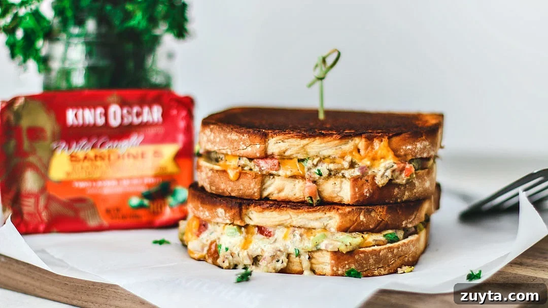 Cheddar Jalapeño Gourmet Grilled Cheese sandwiches stacked on top of one another in a melted mess.