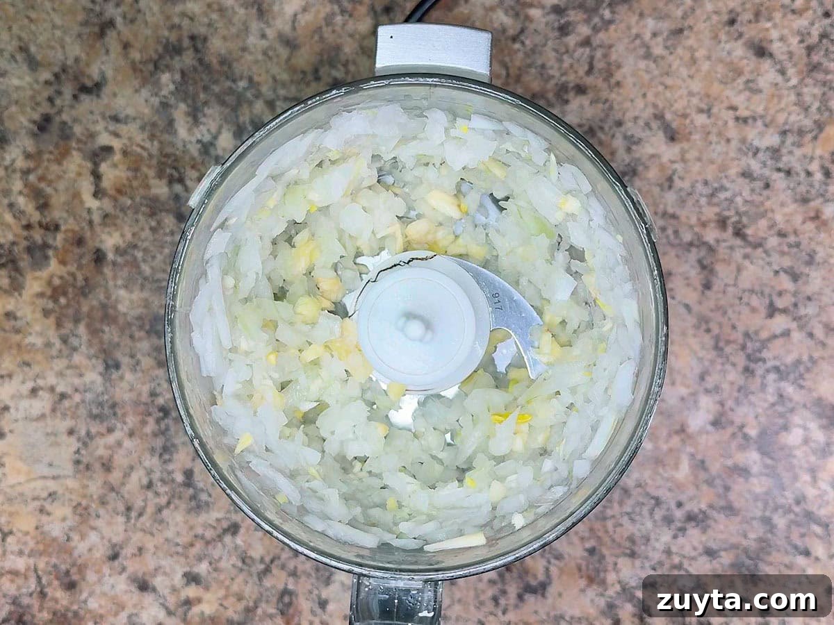 Garden Fresh Salsa Recipe with Tomatoes and Herbs 11 Minced onion and garlic in a food processor.