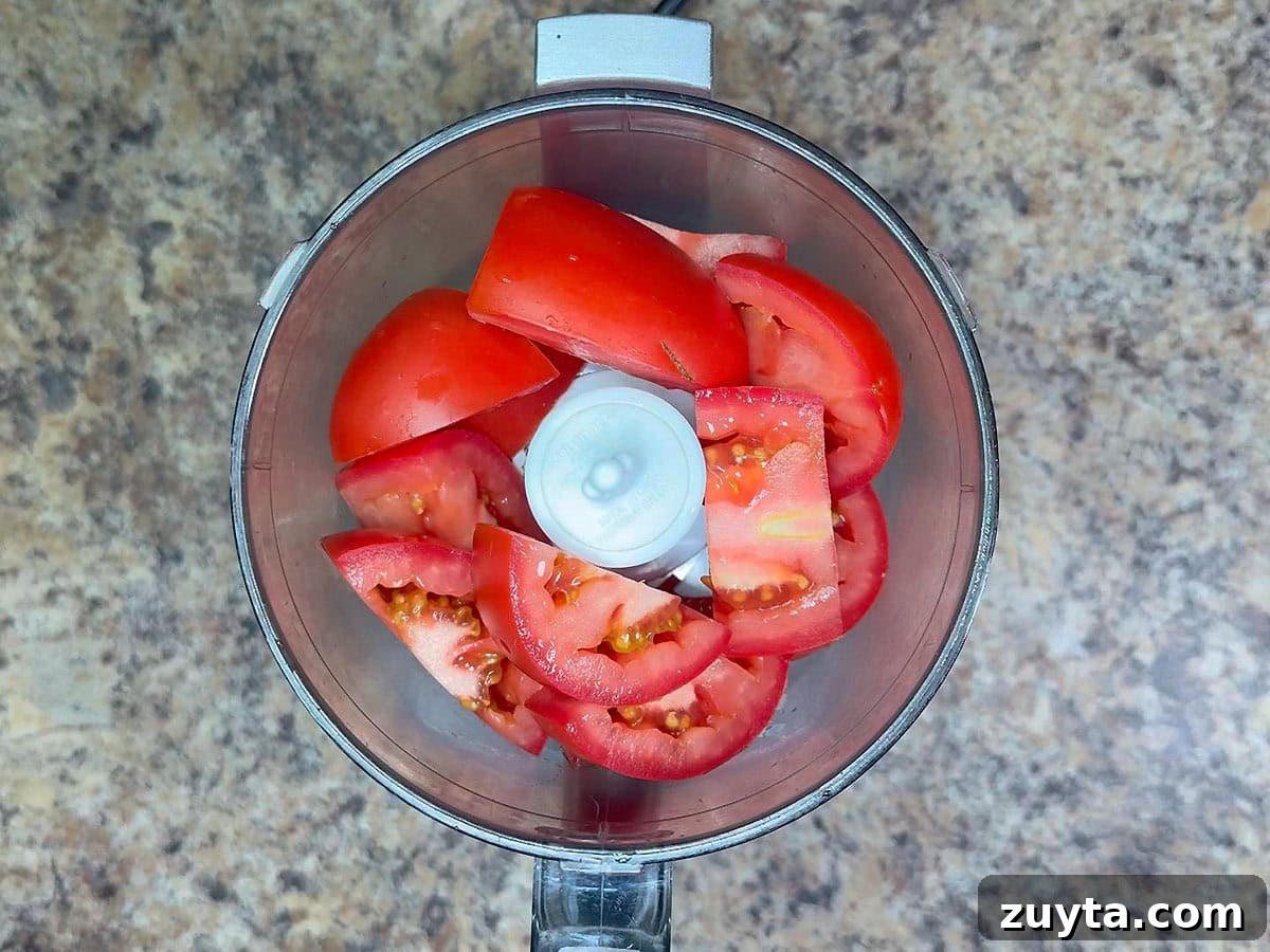 Garden Fresh Salsa Recipe with Tomatoes and Herbs 8 Quartered tomatoes in a food processor.