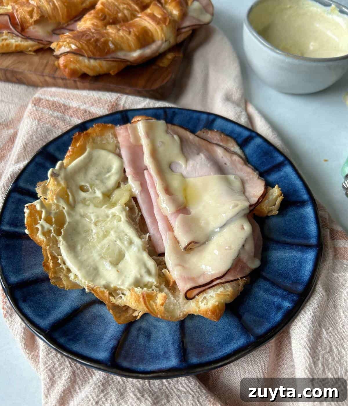 Ham and cheese croissant with dijon spread.
