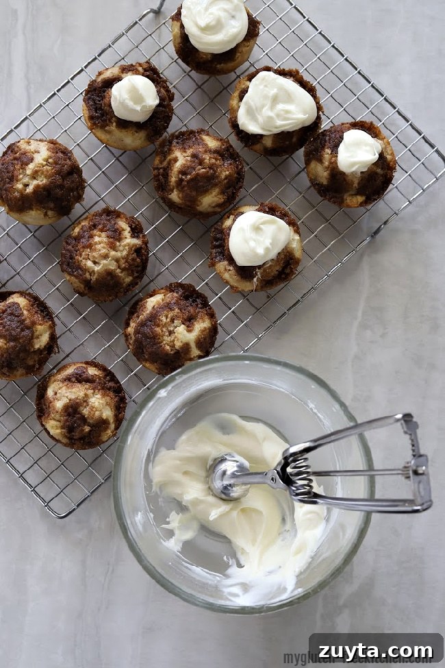 Putting Frosting on gluten-free cinnamon muffins