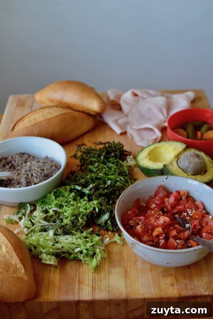 Five essentials for a traditional Mexican torta: bread, avocado, beans, meat, and vegetables