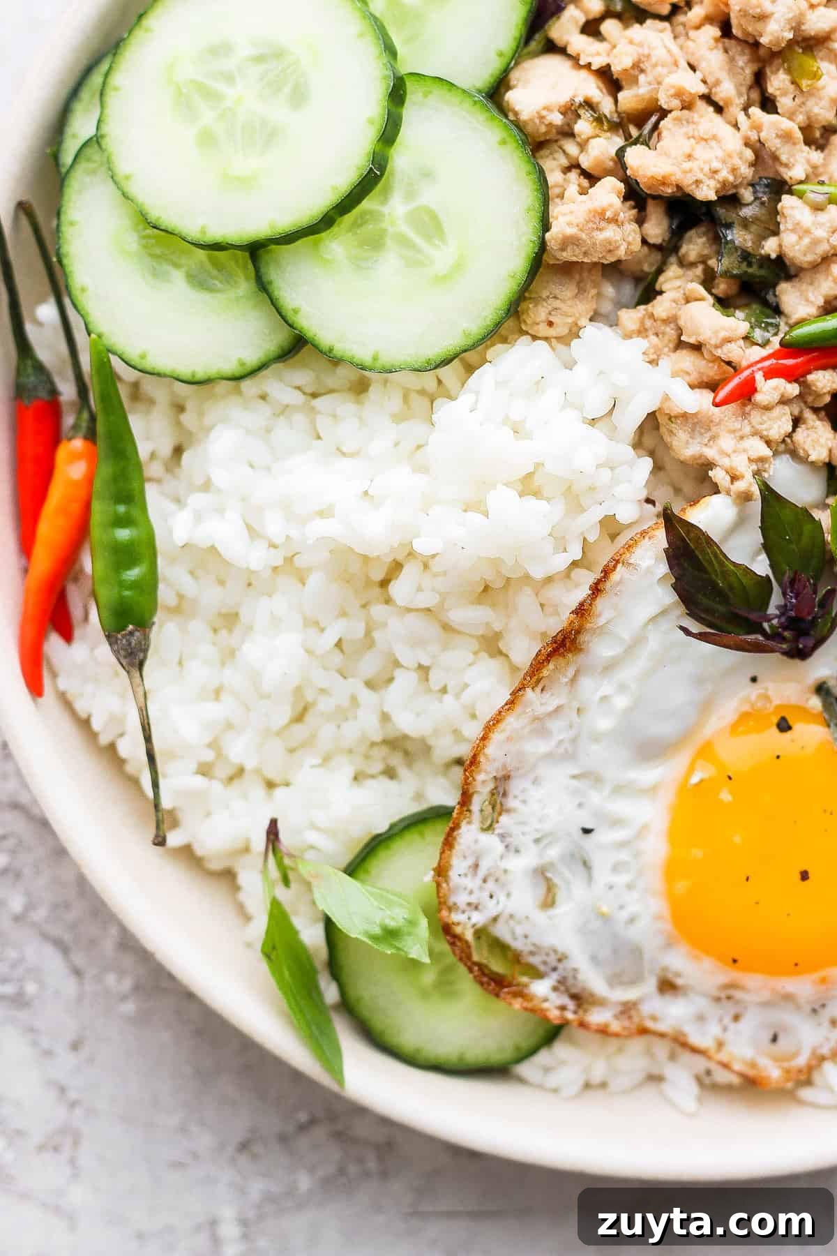 Sticky rice paired with a stir fry sticky rice paired with pad krapow in a bowl
