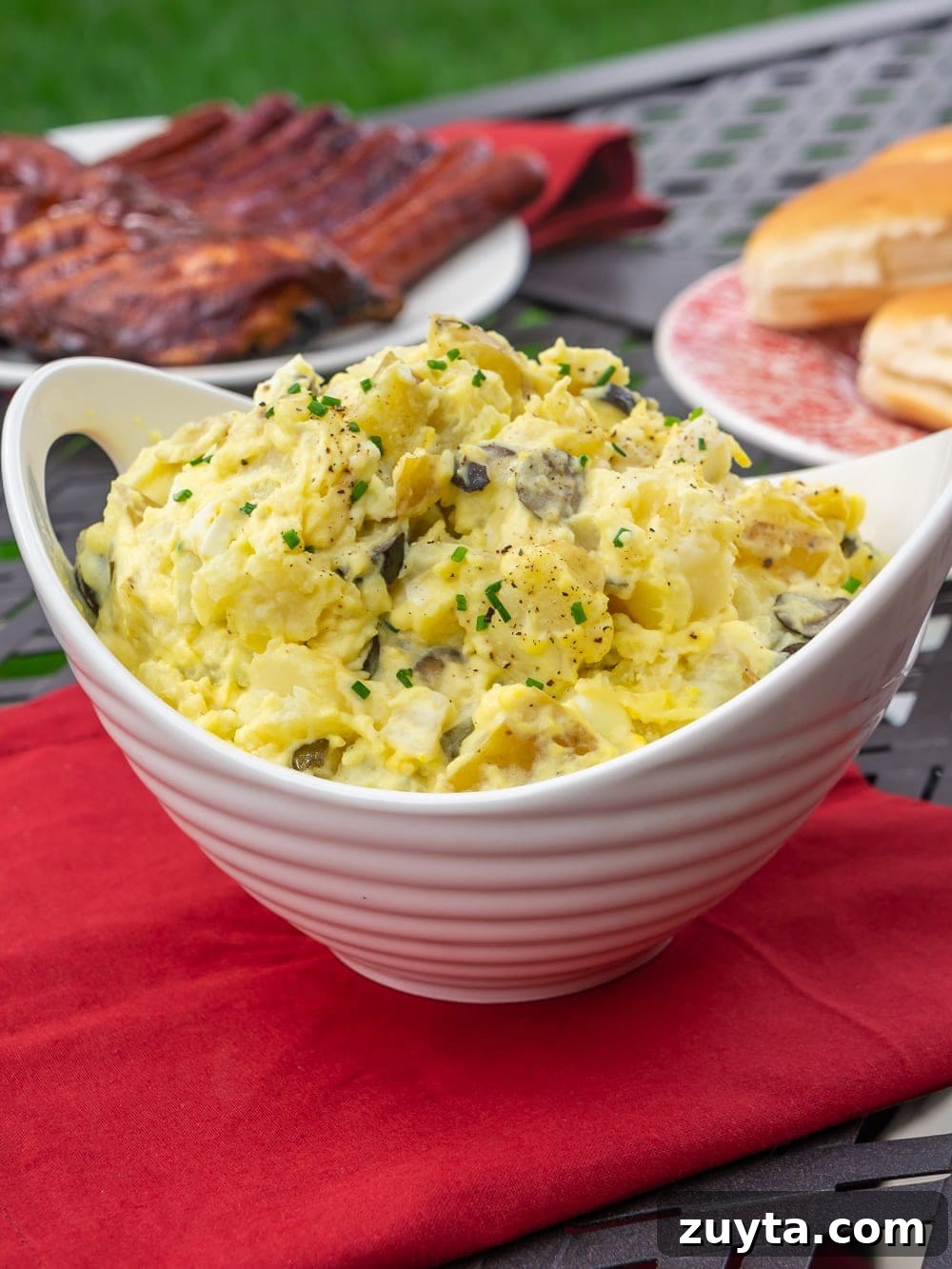 Hot Dog Bar Ideas: Toppings, Themes and Party Setup 7 A bowl of potato salad outside with ribs, hot dogs and buns
