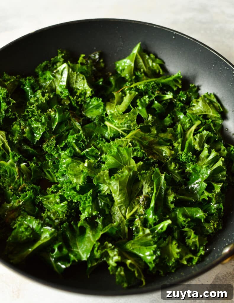 10-Minute Sauteed Kale and Spinach Recipe 4 a skillet with kale in it.