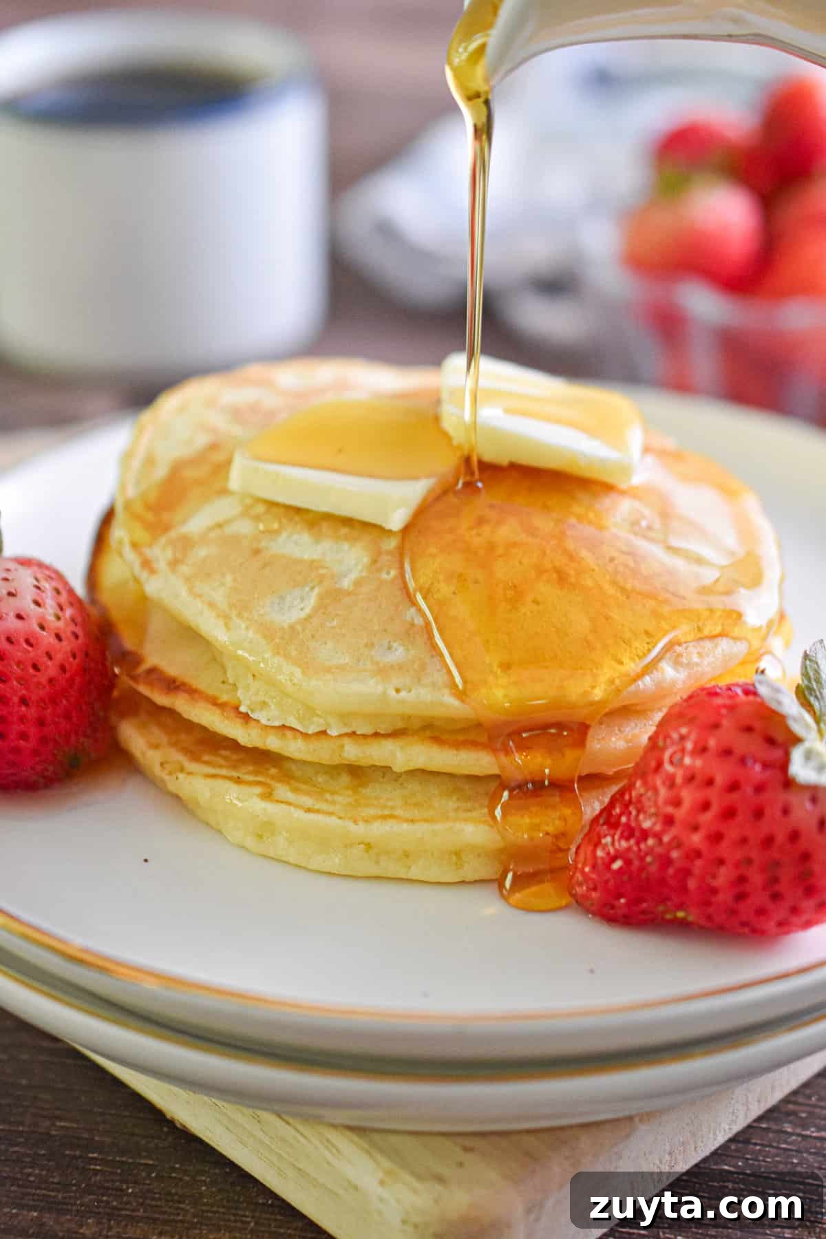 Single-Serving Fluffy Pancakes for One 7 Maple syrup is being poured over a stack of pancakes.